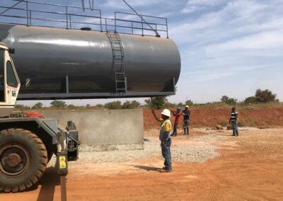Jivan Komarpant, Momentum's HSE Lead providing direction to the crane operator for the fuel tank placement.